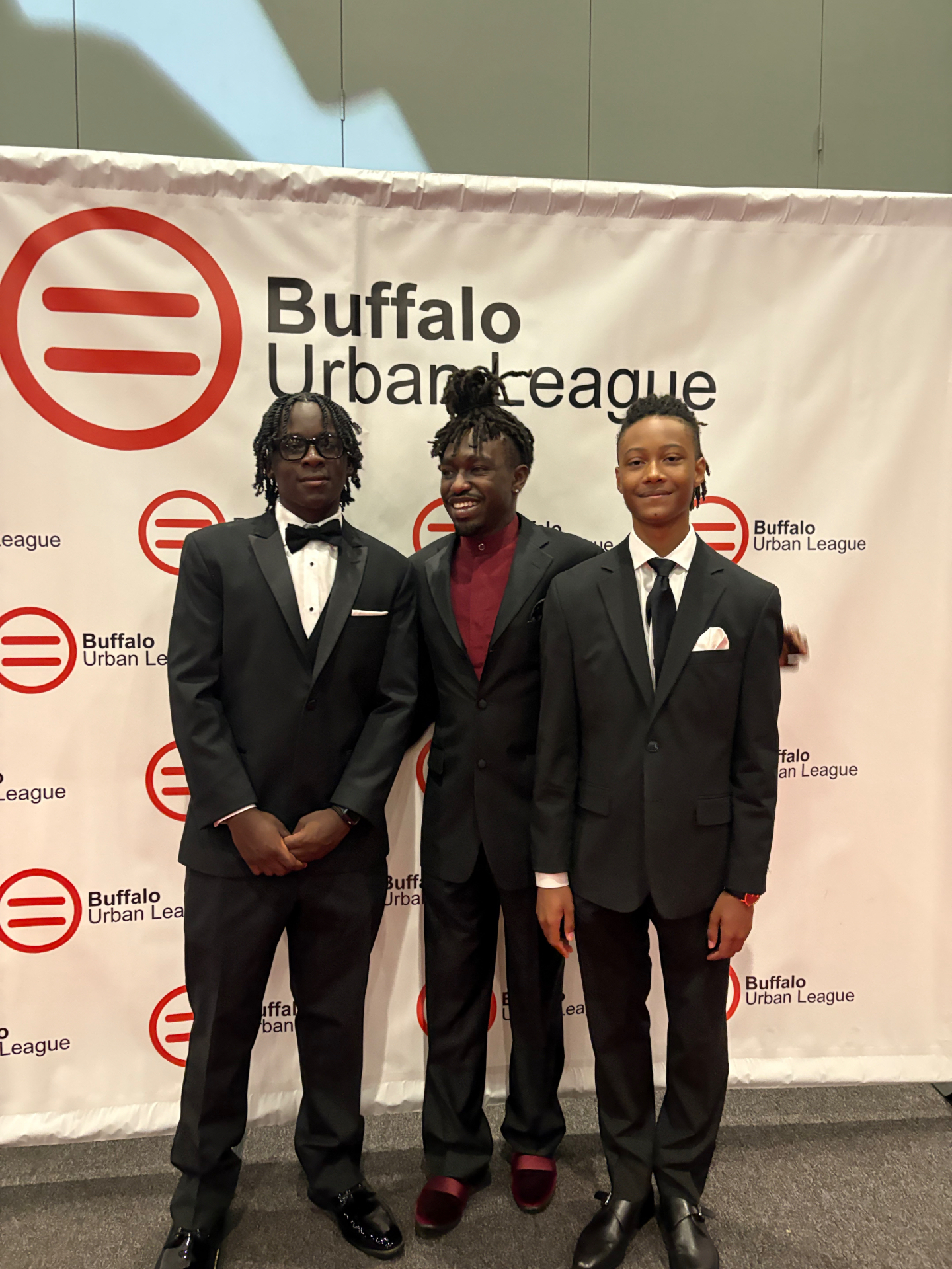 LeMoyne Hill with two young men at the Buffalo Urban League event